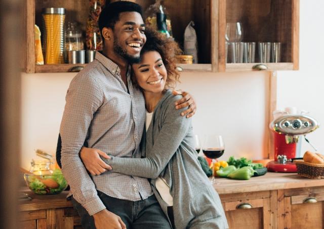 Couple hugging in kitchen